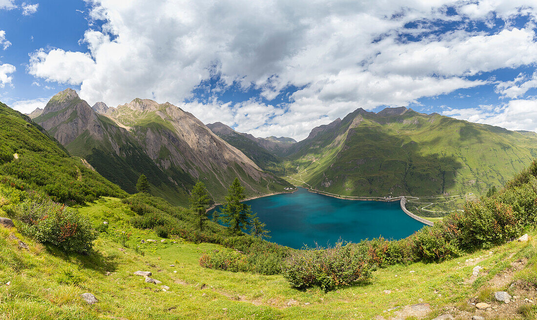 Panoramic view of the Morasco lake and dam with Bettelmatt flat in the distance. Riale hamlet, Formazza, Valle Formazza, Verbano Cusio Ossola, Piedmont, Italy.