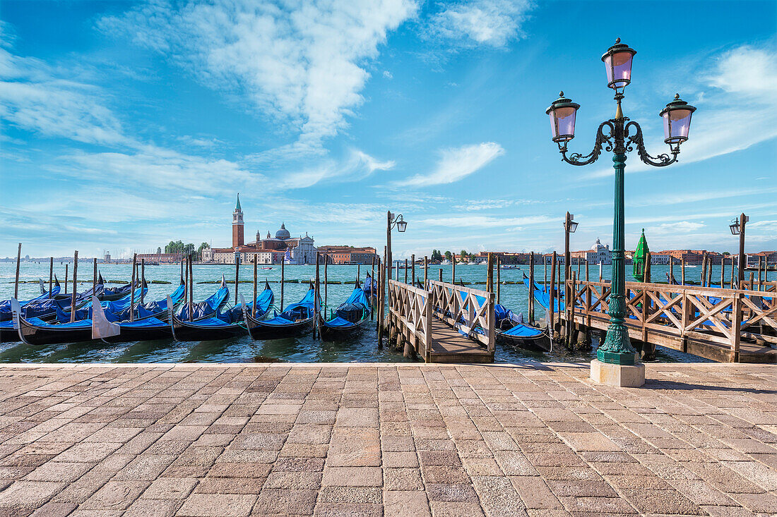 Gondolas of Venice in Riva degli Schiavoni with St. George's island in the background, Venice, Veneto, Italy