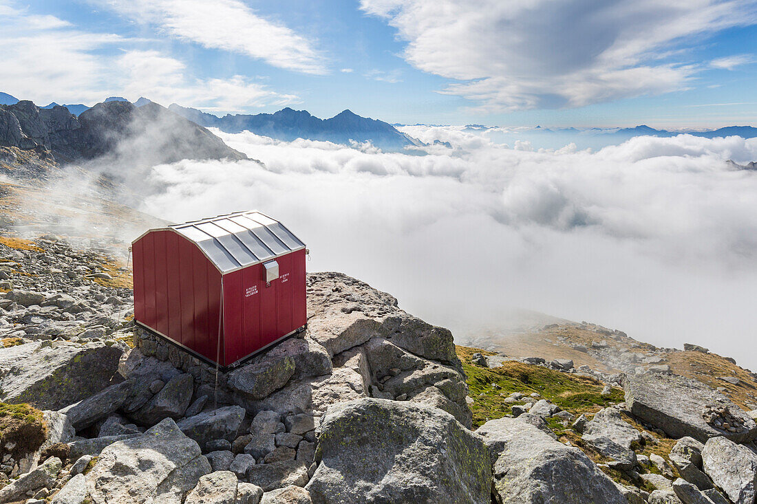 Lombardy, Italy, the Molteni biwak in Ferro valley clouds above. Masino valley