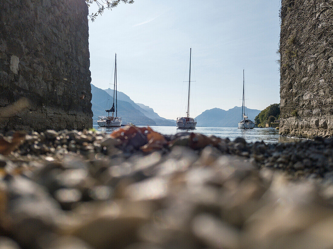 Sailboats in the calm water of Lake Como, Pescallo, Bellagio, Province of Como, Lombardy, Italy