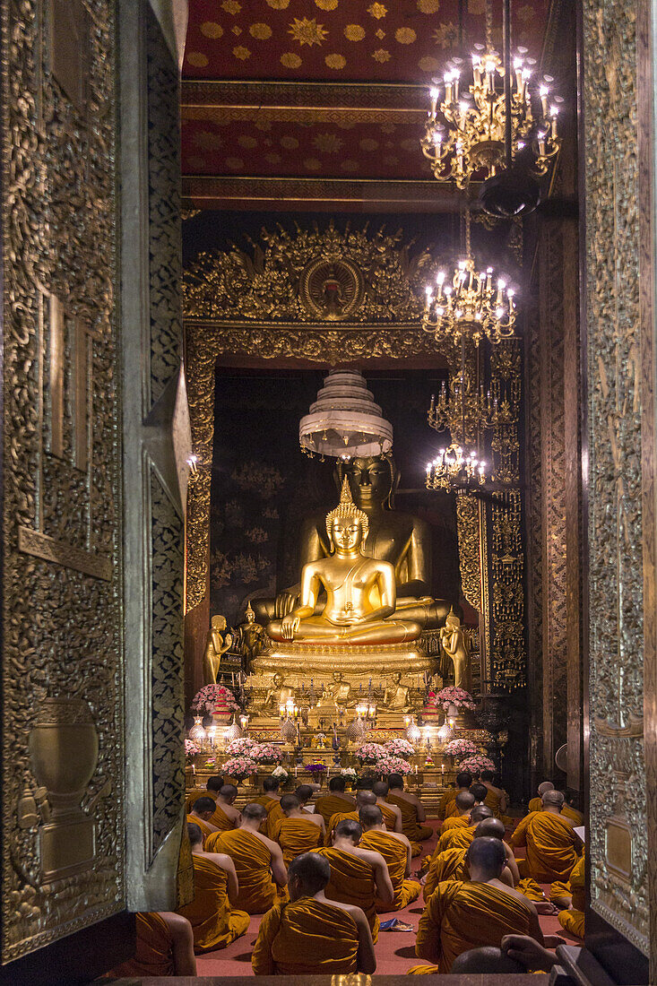 Wat Bowonniwet Vihara, monks at evening praying,Bangkok, Thailand