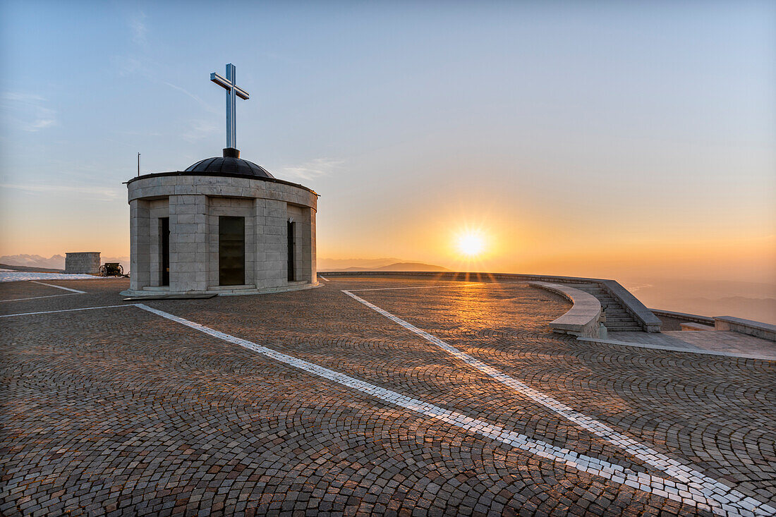 Monte Grappa, province of Vicenza, Veneto, Italy, Europe. On the summit of Monte Grappa there is a military memorial monument. The Sanctuary Madonna del Grappa at sunrise