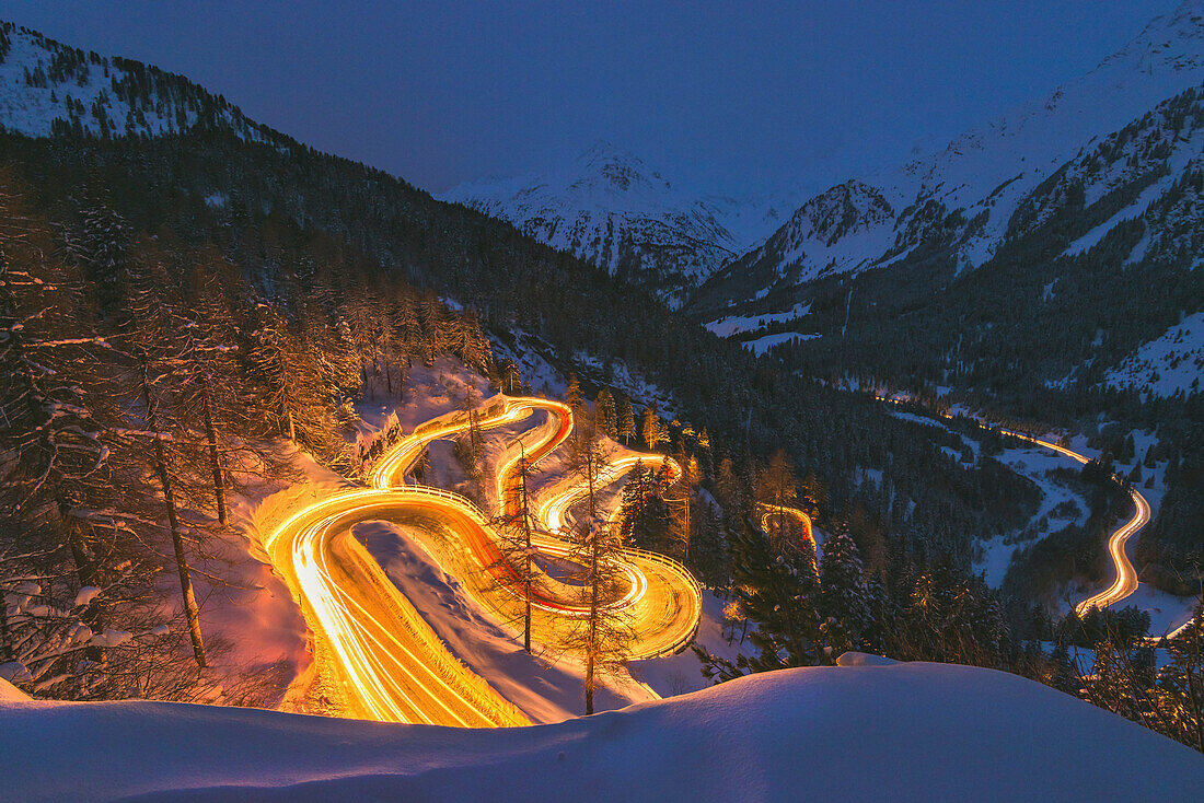 Car lights at night, Maloja Pass, Engadin, canton of Graubunden, Switzerland