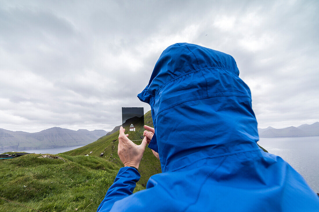 Photographer looks to Kallur Lighthouse through a filter, Kalsoy island, Faroe Islands, Denmark