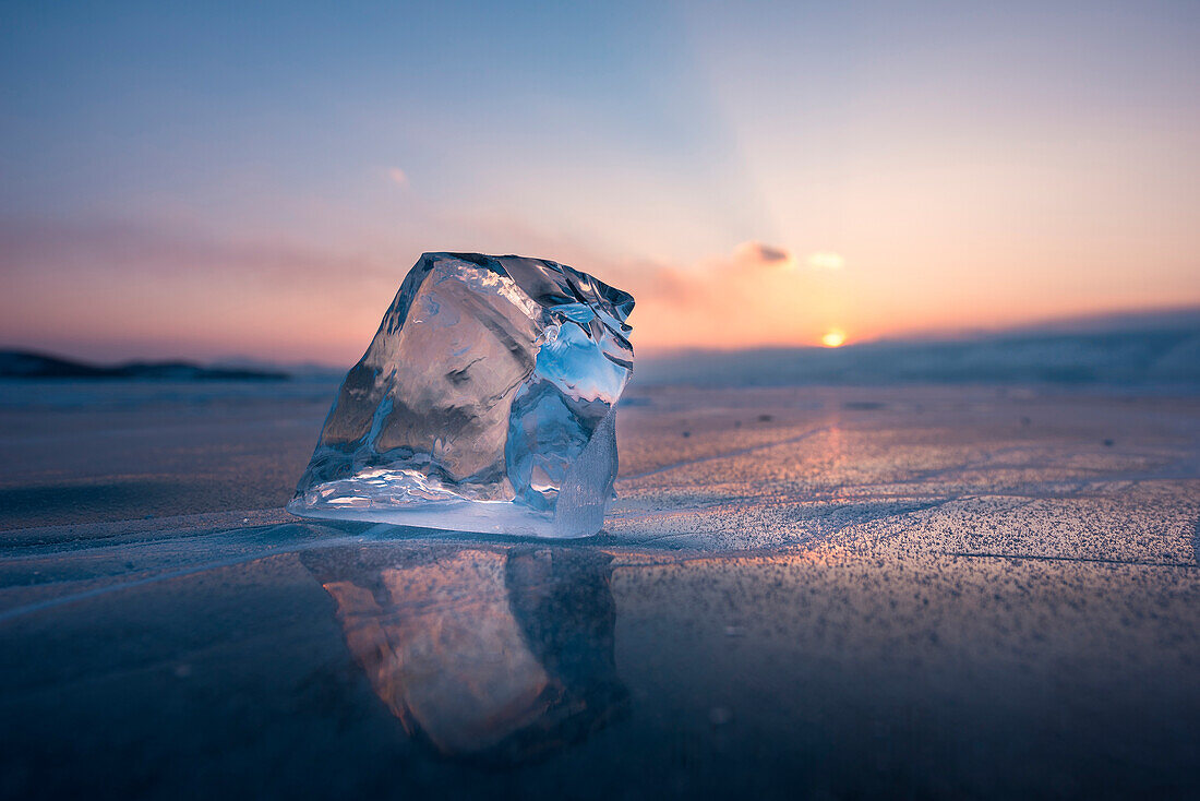 A cube of ice on the flat frosen lake at sunset, Baikal, Irkutsk region, Siberia, Russia
