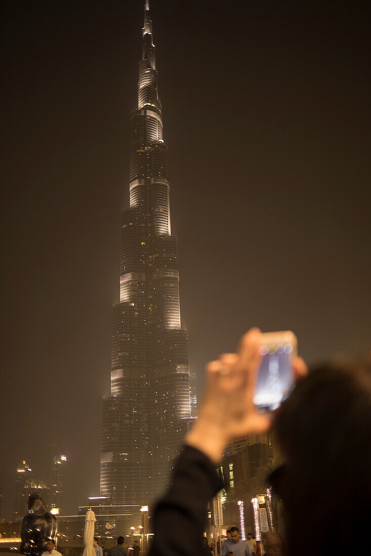 Woman capturing photos of Burj Khalifa in Dubai