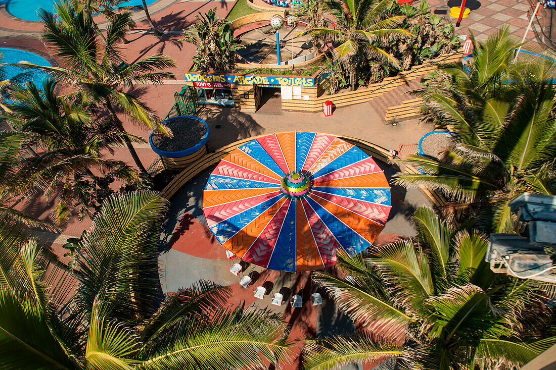 Aerial view of amusement park, rides, and arcade on promenade of Golden Mile in Durban, South Africa