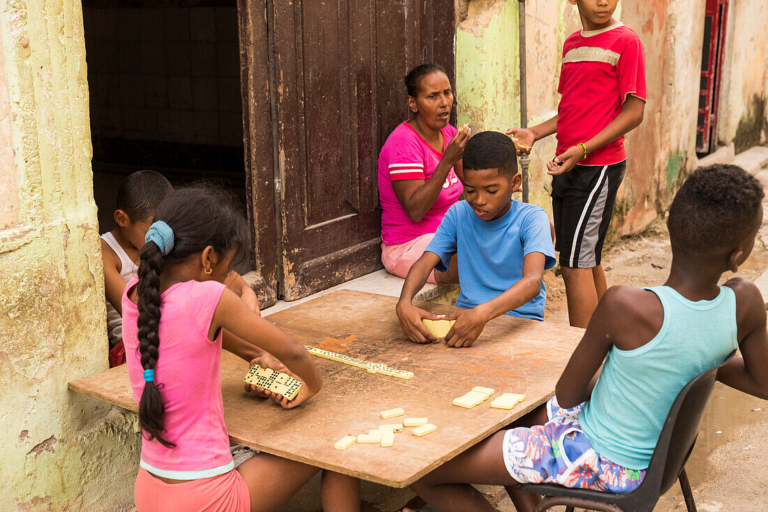 A group of kids play dominos in the street of Havana, Cuba