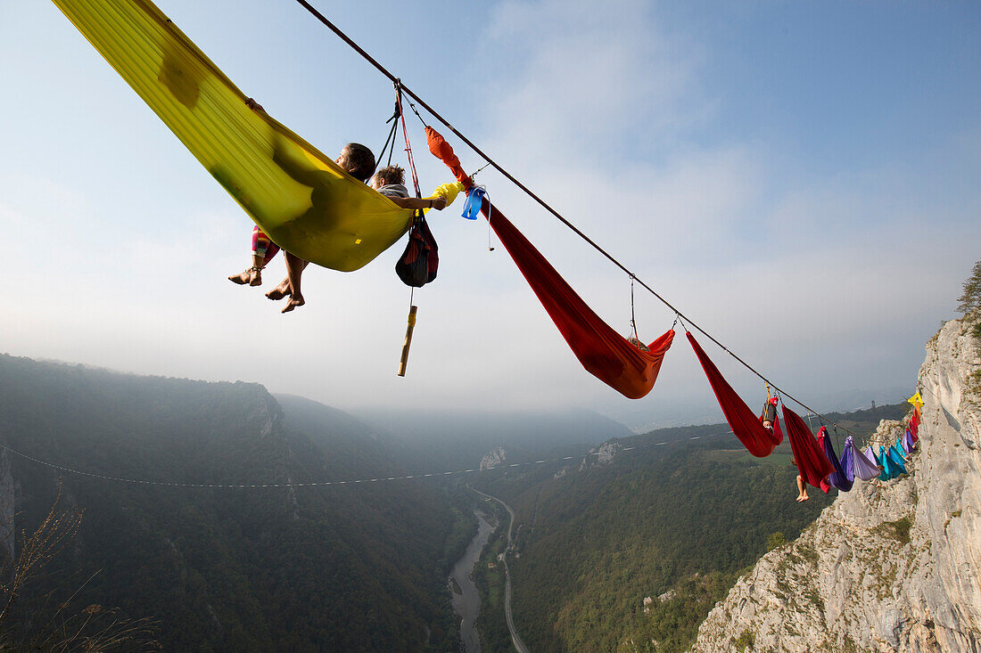 People sleeping in hammock and hanging on high line above mountains, Tijesno Canyon, Banja Luka, Bosnia and Herzegovina