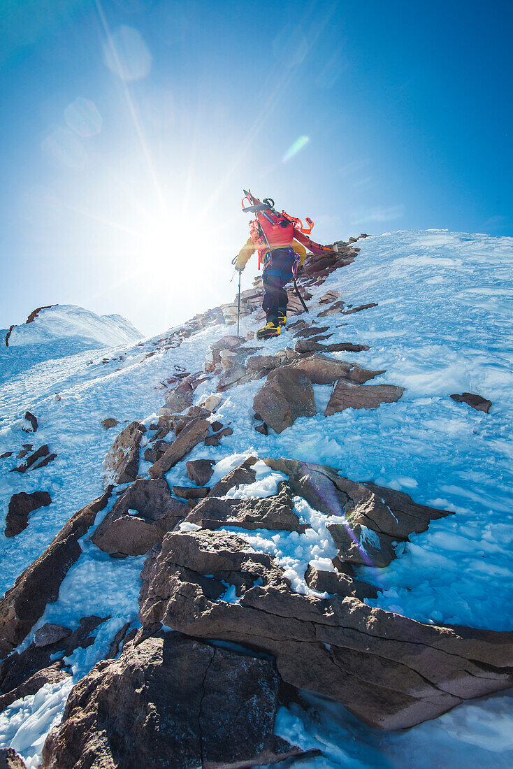 Rear view of lone adventurous mountain climber at Mt Shasta in winter, California, USA