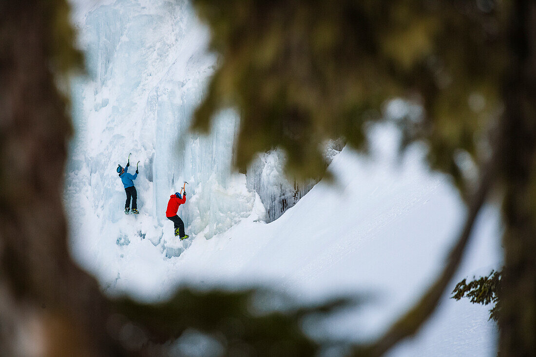 Distant view shot of two men ice climbing, North Cascades National Park, Washington State, USA