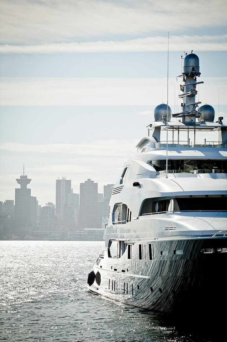 Front view of yacht against skyline of city of Vancouver, British Columbia, Canada