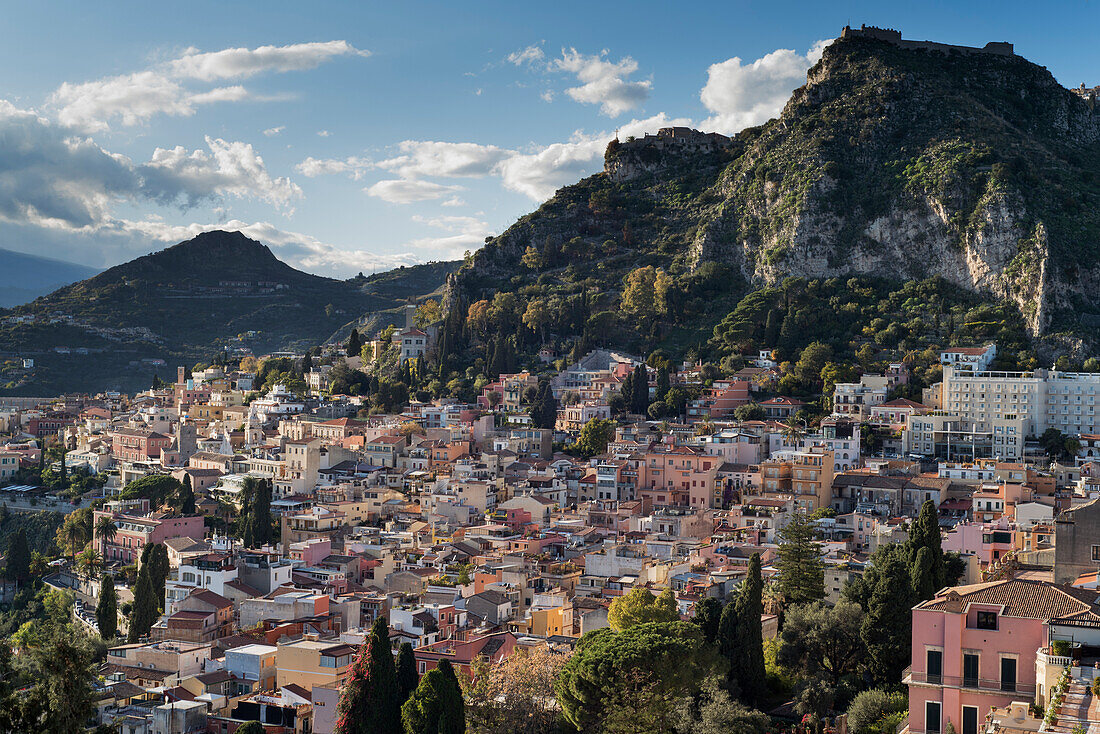 Taormina town seen from Teatro Greco (Greek Theatre) with Mount Etna in background, Sicily, Italy