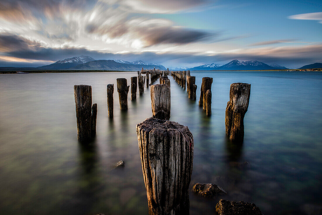 Wooden posts of pier ruins in sea, Patagonia