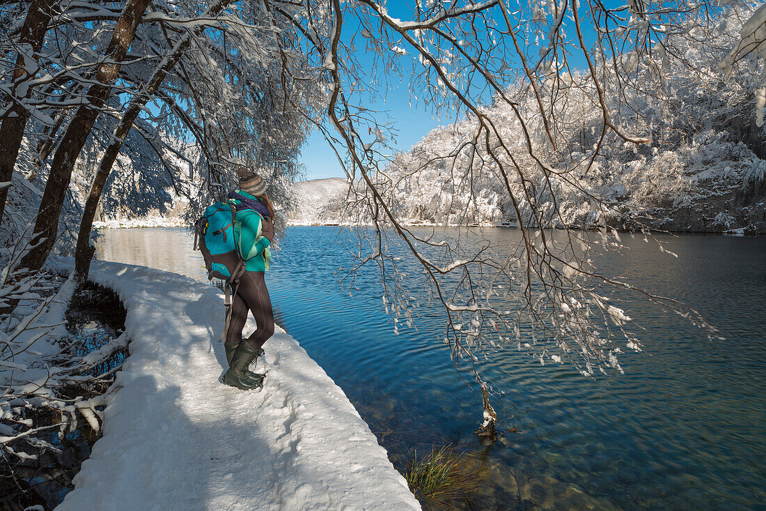 Woman visiting Plitvice Lakes National Park in winter, Plitvicka Jezera, Lika and Senj County, Croatia