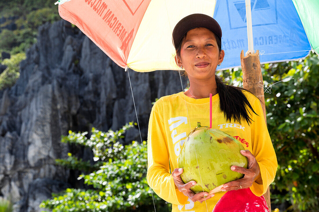 A woman selling coconut milk, El Nido, Palawan, Philippines, Asia