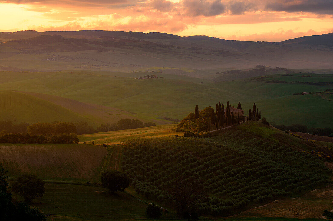 Podere Belvedere, San Quirico d'Orcia, Siena province, Tuscany, Italy. Sunrise over the farmhouse and the hills.
