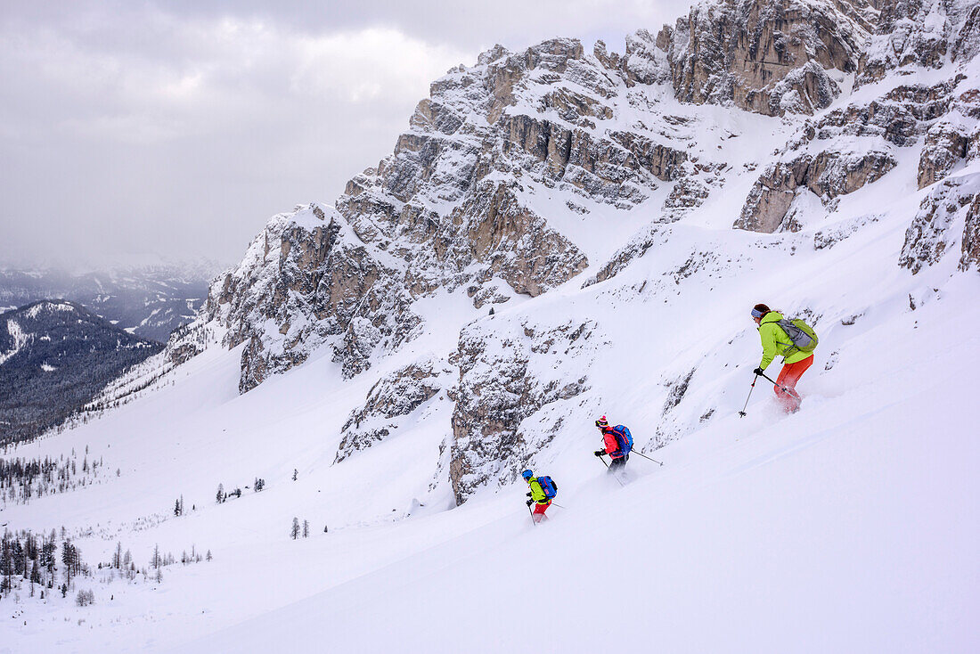 Three persons backcountry skiing descending from Forcella Roa, Forcella Roa, Natural Park Puez-Geisler, UNESCO world heritage site Dolomites, Dolomites, South Tyrol, Italy