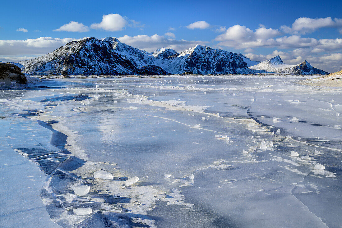 Icy beach with snow-covered mountains, Lofoten, Nordland, Norway