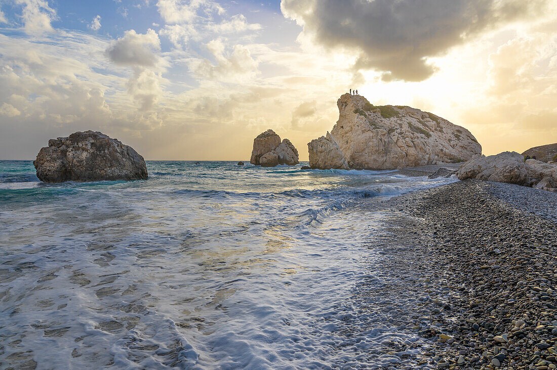 Cyprus, Paphos, Petra tou Romiou also known as Aphrodite’s Rock, boys at the sunset standing over the rock