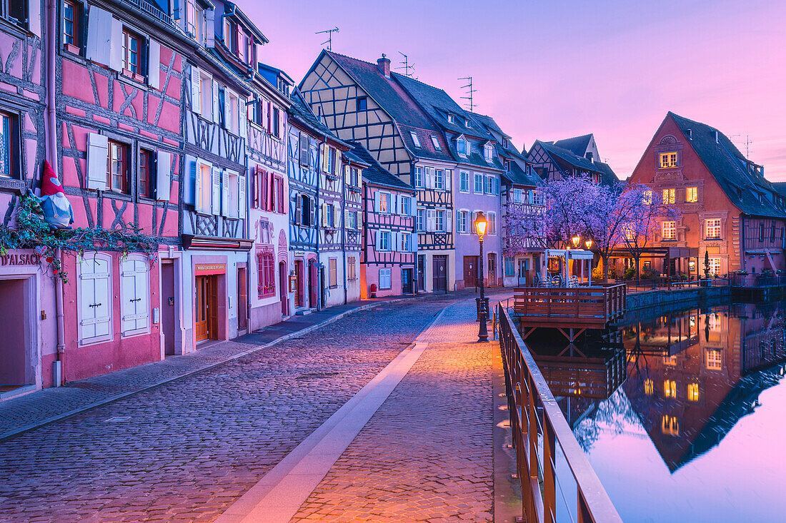 Canal waterfront view of traditional townhouses at dusk, Colmar, Grand Est, France