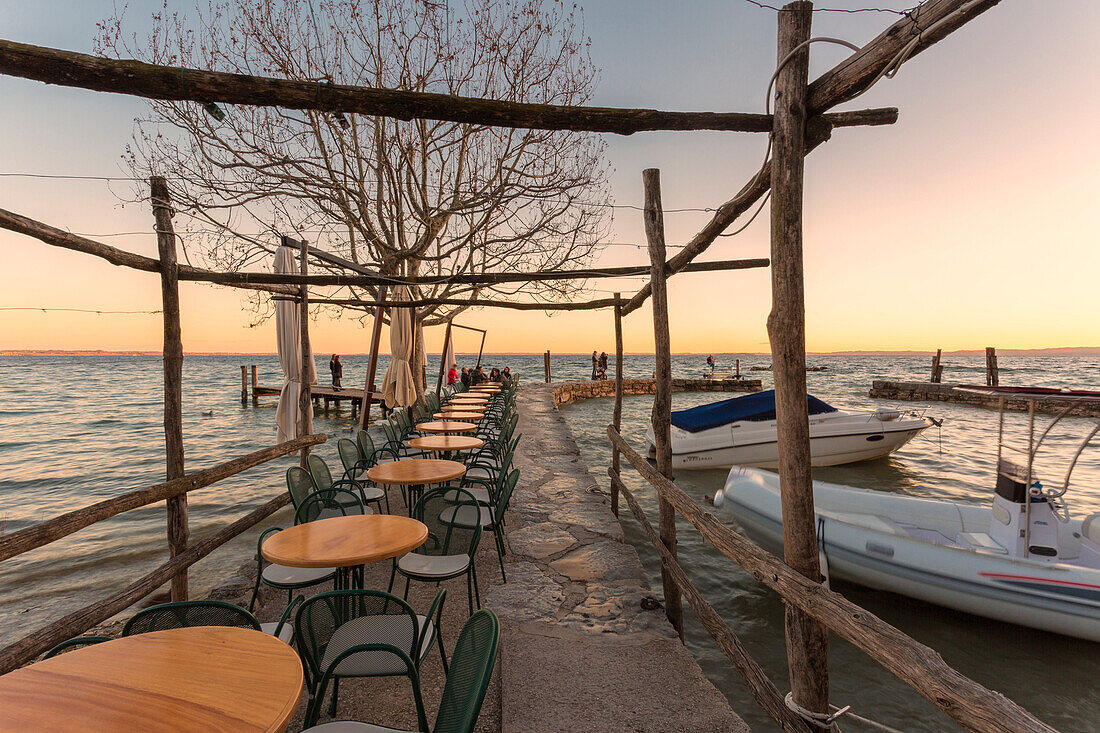 The lakefront restaurant of Punta San Vigilio on the eastern shore of Lake Garda, Verona province, Veneto, Italy.