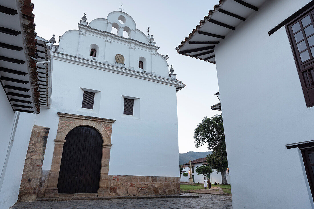 white dressed nuns having a conversation in front of catholic church Iglesia del Carmen at historic town Villa de Leyva, Departamento Boyacá, Colombia, South America