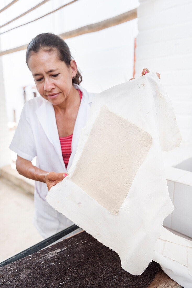 woman working at historical Paper Production at Fundación San Lorenzo, Barichara, Departmento Santander, Colombia, Southamerica