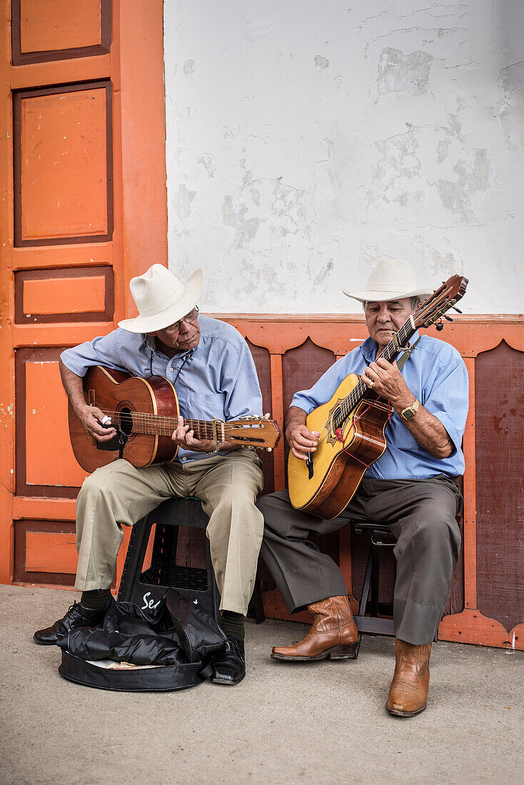 two old Colombian street musicians with hat at alleys of Salento, UNESCO World Heritage Coffee Triangle, Departmento Quindio, Colombia, Southamerica