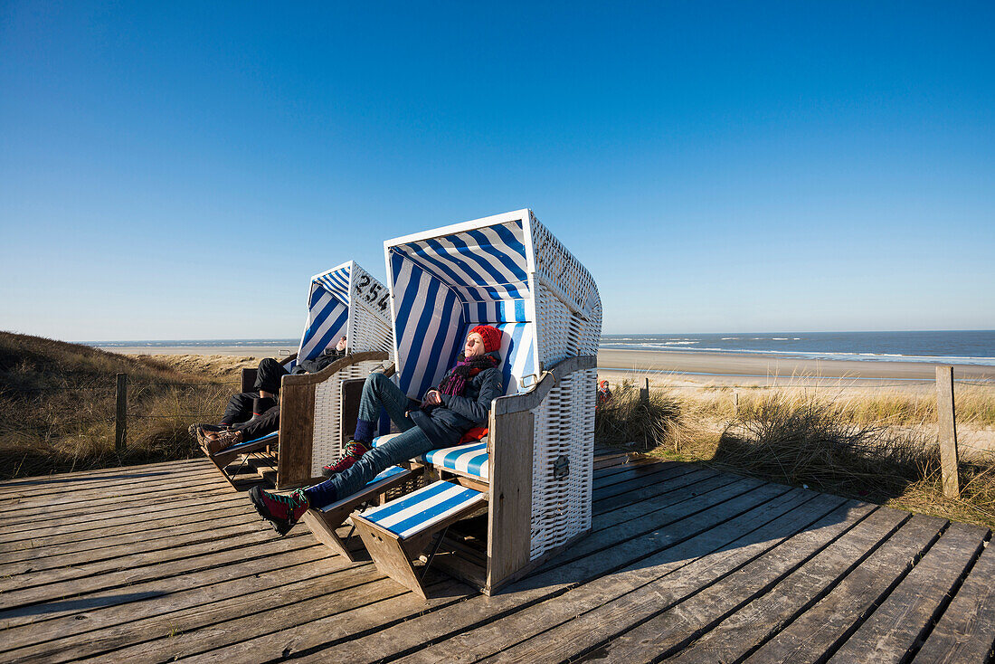 Beach chairs and blue sky in winter, East Frisian Islands, Spiekeroog, Lower Saxony, North Sea, Germany