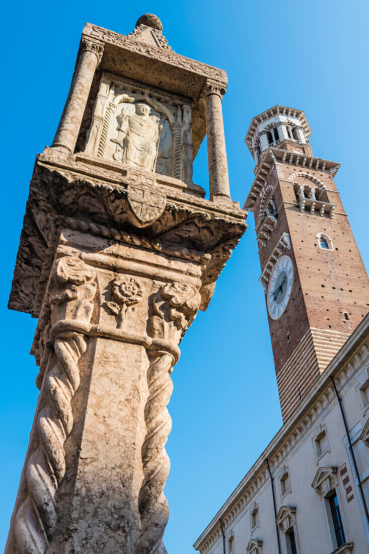 The Colonna Antica column on Piazza delle Erbe in front of the Lamberti Tower, Verona, Veneto, Italy