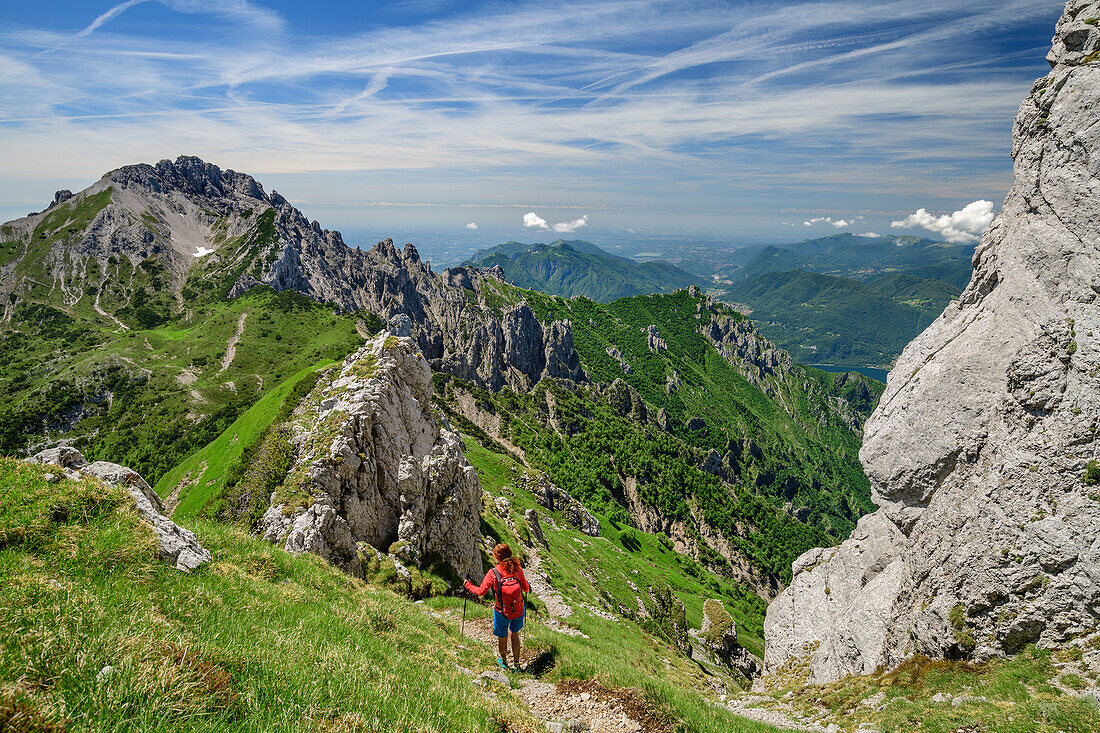 Woman hiking from Grignone towards Grignetta, Grigna, Bergamasque Alps, Lombardy, Italy