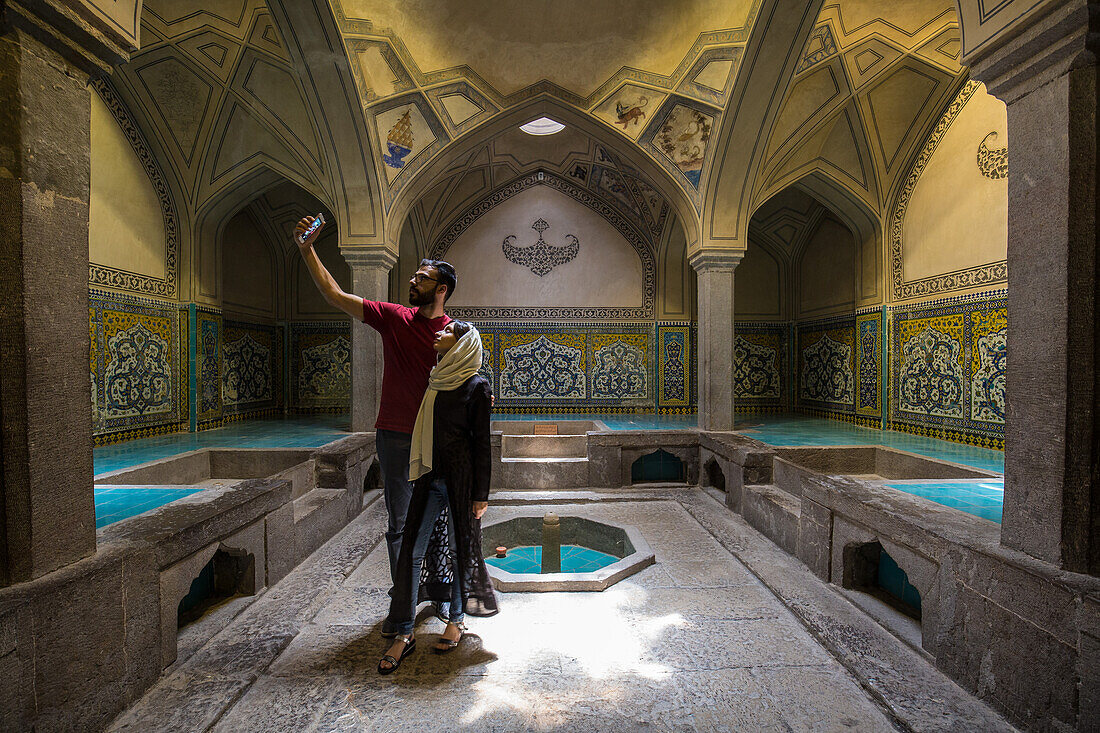 young couple in traditional hamam Ali Gholi in Esfahan, Iran, Asia
