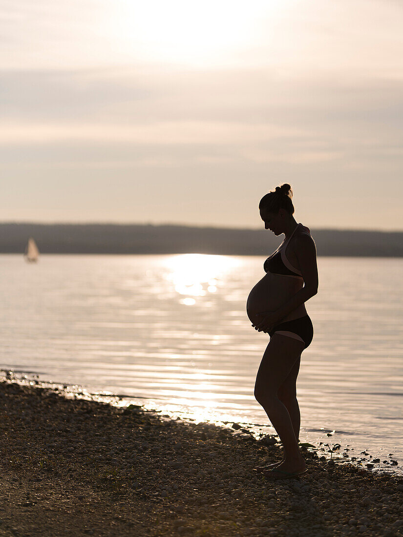 pregnant women at the shore of lake Ammersee,  Bavaria, Germany