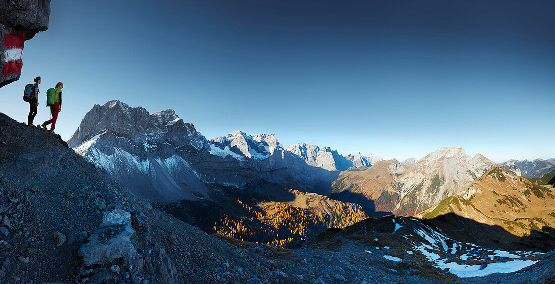 two women hiking in underneath Hahnkampl, Lamsenspitze in the back ,  Eastern Karwendel Range, Tyrol, Austria