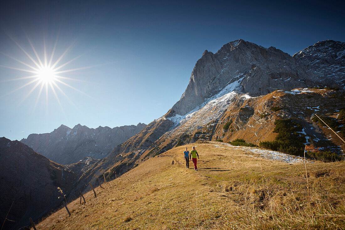 Two women ascending Hahnkampl, Lamsenspitze in the back,  Eastern Karwendel Range, Tyrol, Austria
