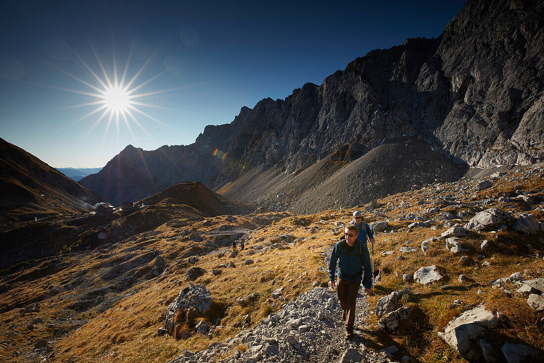 Hikers on the path to Lamsenspitze, Stallenta valley in the back,  Eastern Karwendel Range, Tyrol, Austria