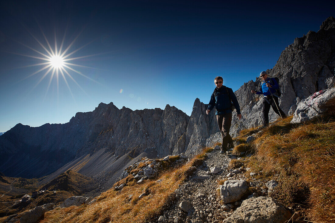Two hiker coming from Lamsenspitze, Stallental valley in the back,  Eastern Karwendel Range, Tyrol, Austria