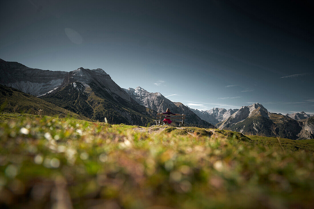 woman on a bench on Plumsjoch,  Plumsjoch, Karwendel mountains, Tyrol, Austria