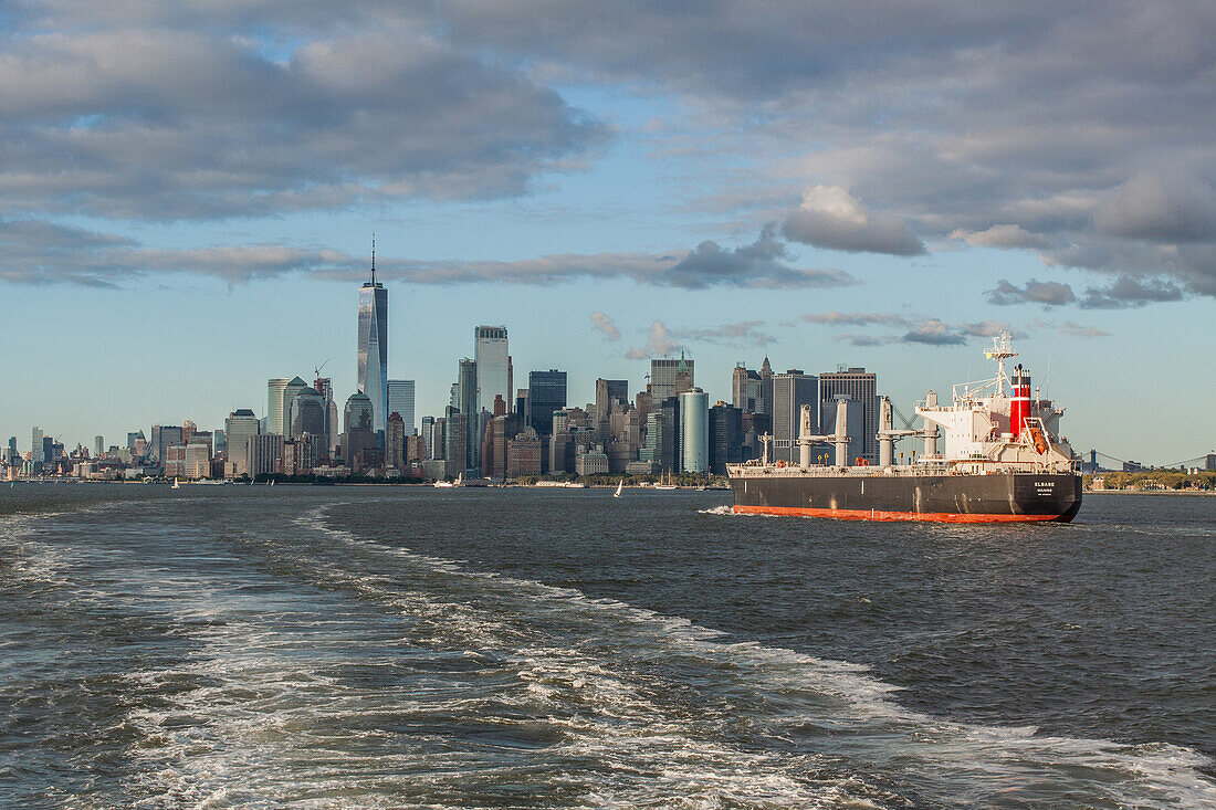 oil tanker entering the port of new york with the manhattan skyline and one world trade center in the background, manhattan, new york city, new york, united states, usa