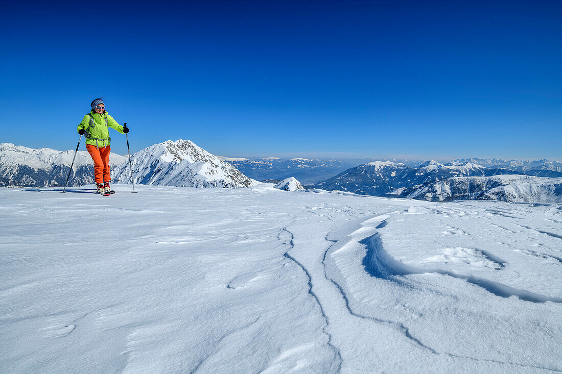 Woman backcountry-skiing ascending towards Hoher Bolz, Hoher Bolz, Kreuzeck Group, Hohe Tauern range, Carinthia, Austria
