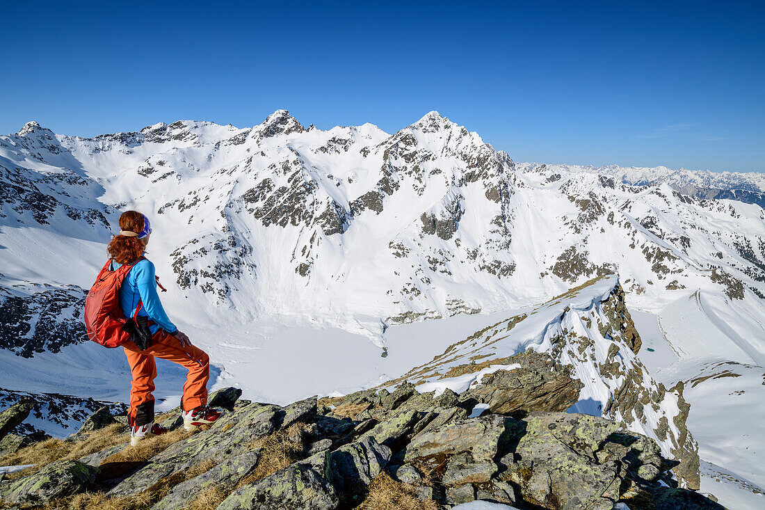 Woman backcountry-skiing looking towards Zwoelferkogel, Steintalspitze, Sellrain, Stubai Alps, Tyrol, Austria