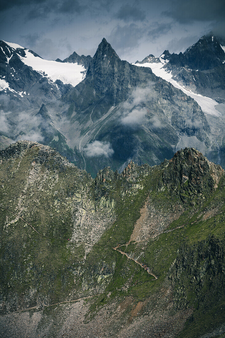 Hiker on the ascent with mountain massif in the background, E5, Alpenüberquerung, 5th stage, Braunschweiger Hütte,Ötztal, Rettenbachferner, Tiefenbachferner, Panoramaweg to Vent, tyrol, austria, Alps