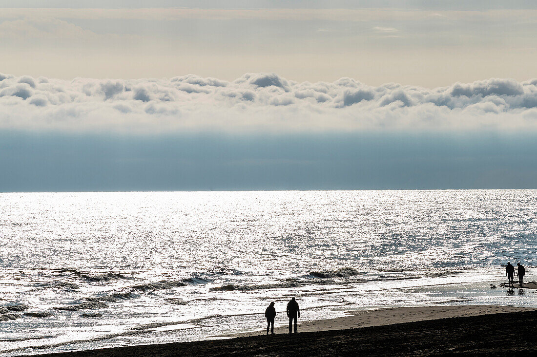 Beach walker after sunrise, Wangerooge, East Frisia, Lower Saxony, Germany