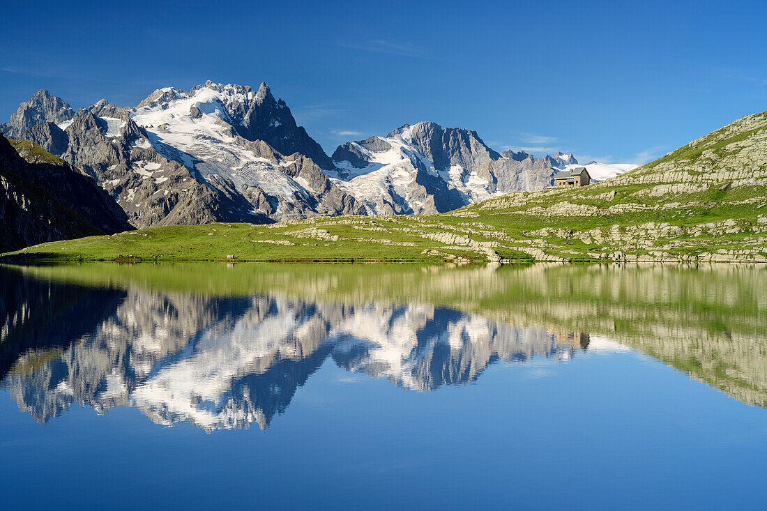 Lake Lac du Goléon with hut Refuge du Goléon and view towards Meije in Ecrins region, lake Lac du Goléon, National Park Ecrins, Dauphine, Dauphiné, Hautes Alpes, France