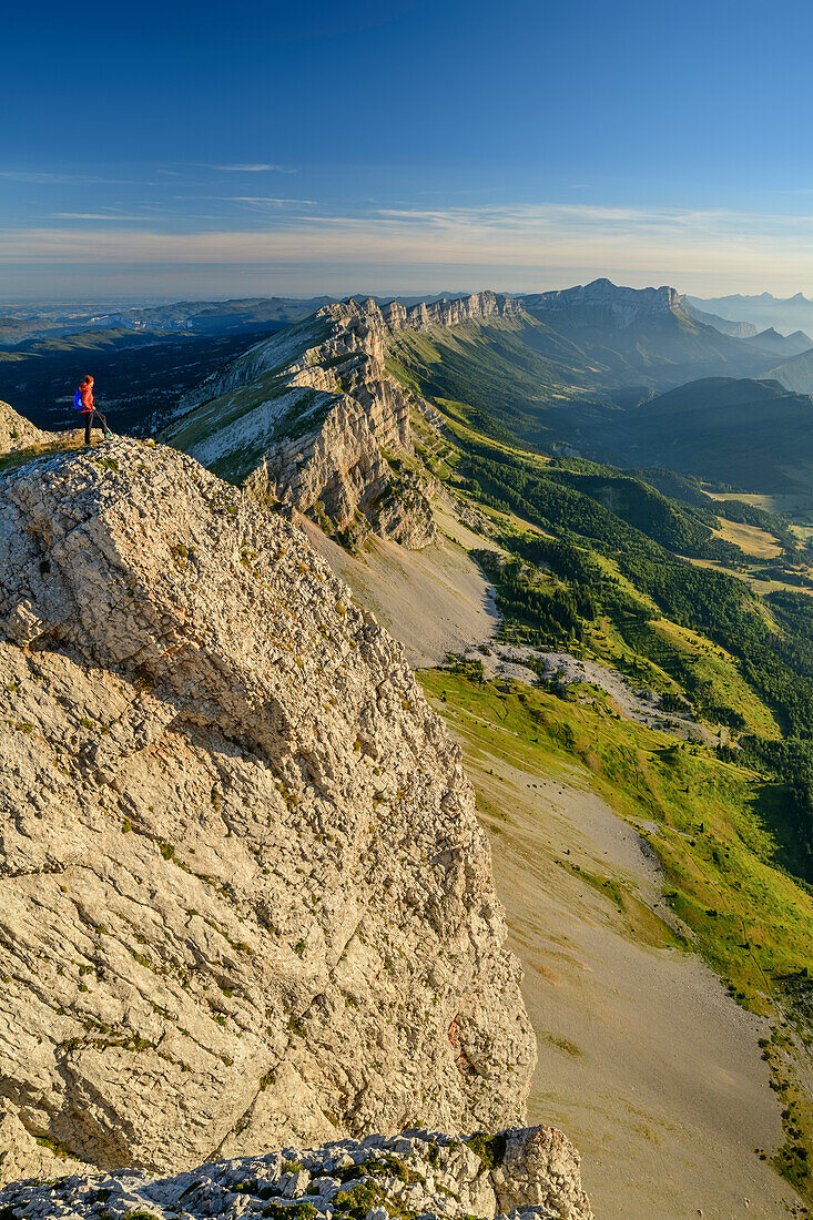 Woman while hiking on the mountains of the Vercors looks with mouche role in the background, from the Grand Veymont, Vercors, Dauphine, Dauphine, Isère, France