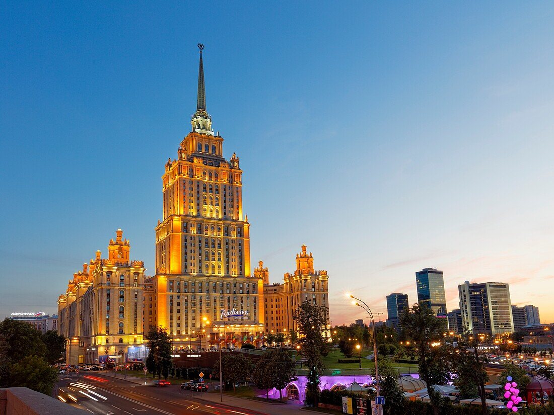 Radisson Royal Hotel Stalinist style high-rise building illuminated at dusk. Moscow, Russia.