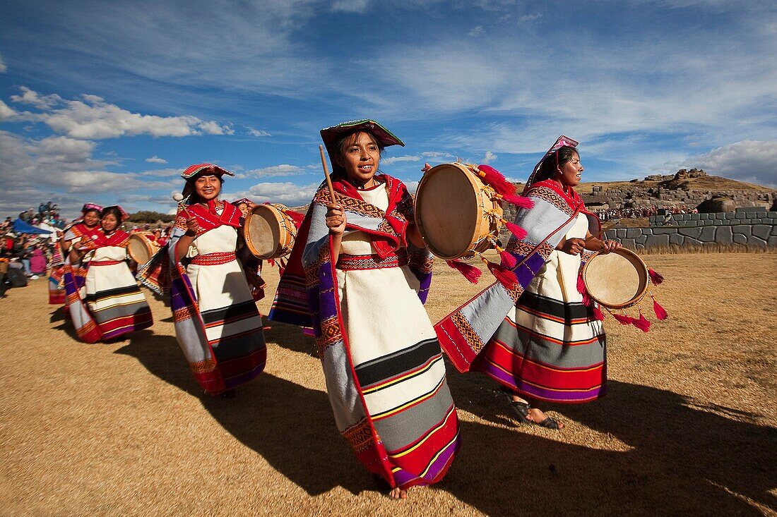 Indigenous people with traditional costumes during a performance at the Inti Raymi Festival in Saqsaywaman Archaeological Site, Cusco, Peru, South America.