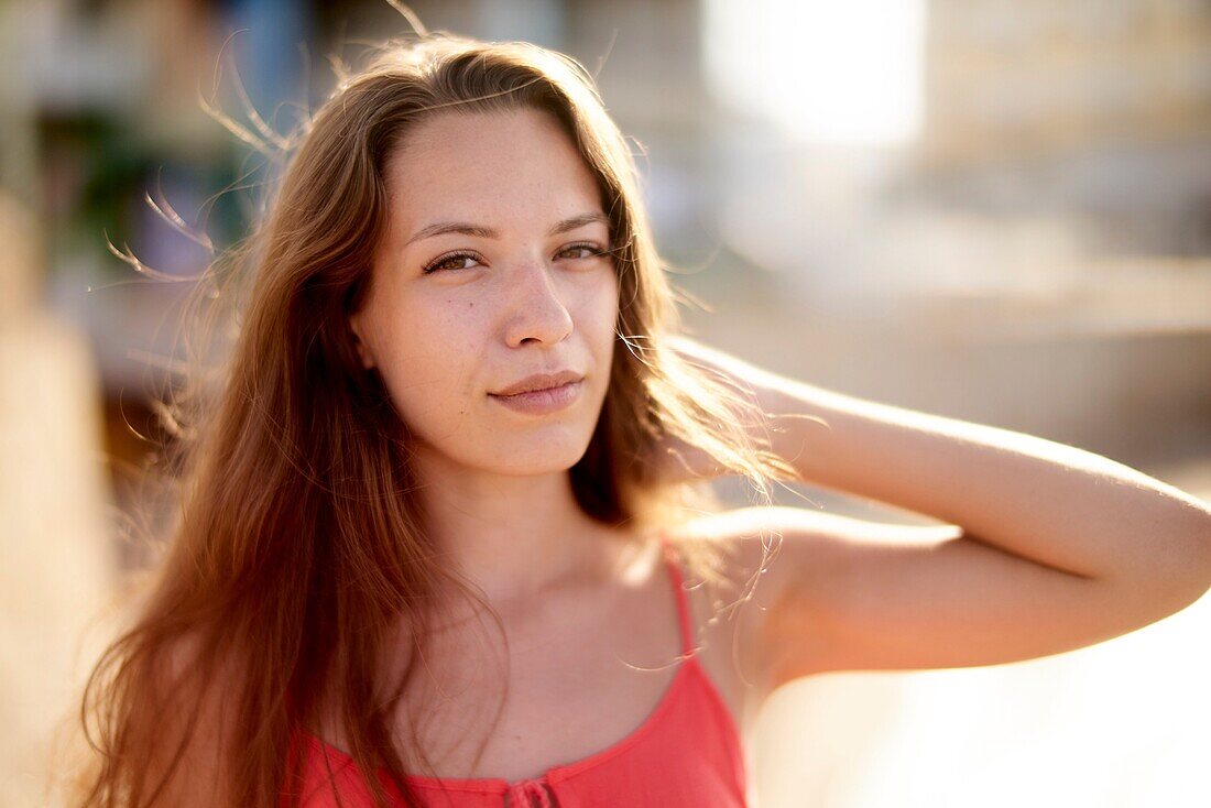 Portrait of woman at beach in beautiful sunlight in holiday destination Chersonissos, Crete, Greece