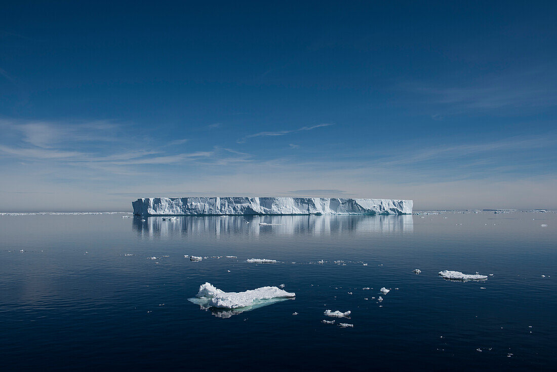 A large tabular iceberg floats in a virtually windless, calm sea, near Paulet Island, Antarctic Peninsula, Antarctica